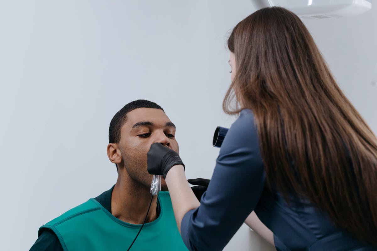 a man being being checked for dental issues